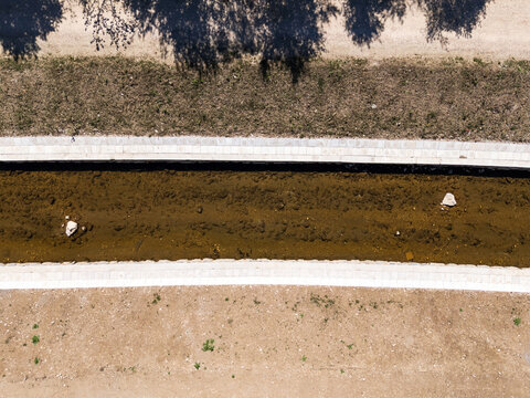 A river restoration project involving channel widening and flood embankment works. Aerial view captures the ongoing activity.