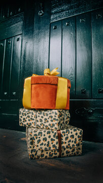 Christmas gifts in boxes by the door of a house, holiday season