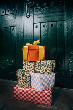 Christmas gifts in boxes by the door of a house, holiday season