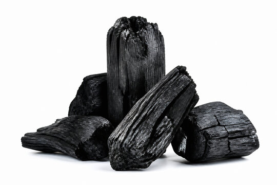 Several pieces of dark, rough-cut wood or charcoal are displayed against a white background.