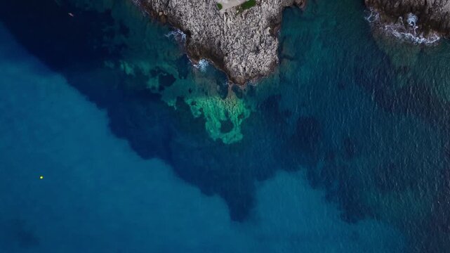 Aerial view of rocky coastline and clear blue sea near Montecarlo, Monaco