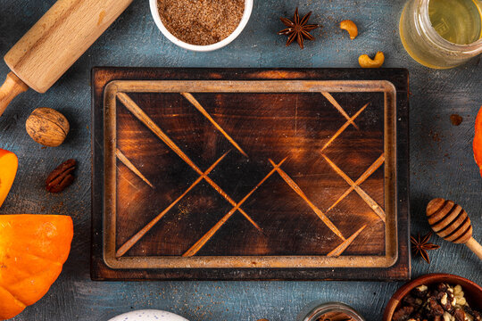 Fall baking, cooking seasonal dessert background with various ingredients - honey, pumpkin squash, brown sugar, cinnamon, spices, red apples, plums, walnuts, pecans. Autumn, thanksgiving bakery backgr