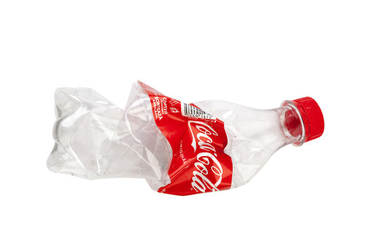 Crushing a plastic Coca-Cola bottle for recycling
