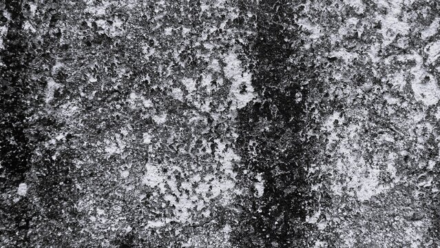 Abstract black and white textured wall with fine granular details, distressed areas and natural surface variations, ideal for industrial backgrounds and graphic design.