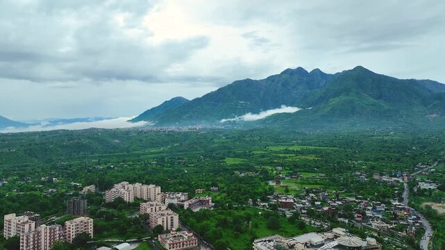 Aerial shot of lush green Trikuta Hills in Katra highlighting Mata Vaishno Devi pilgrimage route.