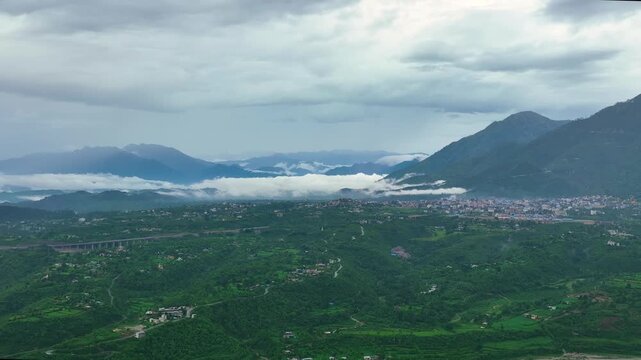 Aerial shot of lush green Trikuta Hills in Katra highlighting Mata Vaishno Devi pilgrimage route.