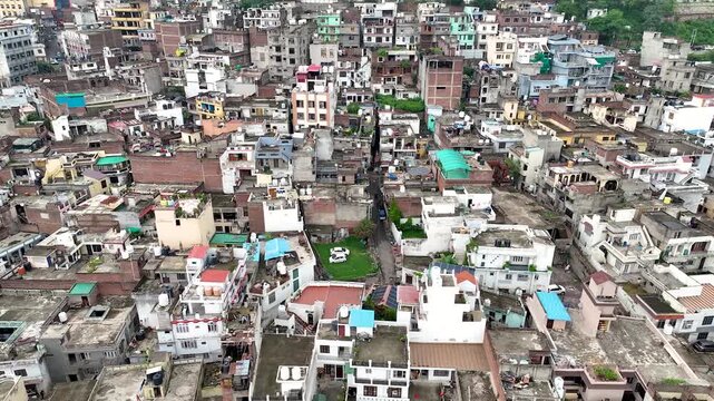 Aerial shot across a dense Poorly planned Indian city area showcasing extreme overpopulation and poverty.