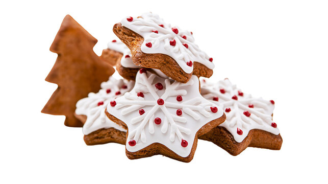 Gingerbread star cookies with white icing and red sugar pearls and tree cookie