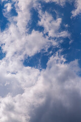 Obraz premium Blue Sky With Fluffy White Clouds and Dramatic Sunlit Cloudscape Overhead