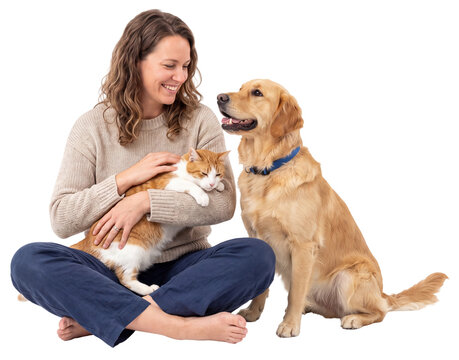 smiling woman holding a cat while sitting beside a golden dog