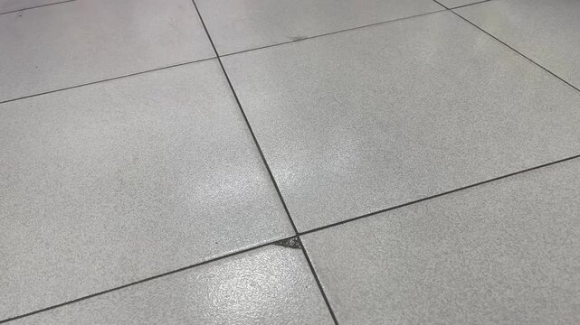 High angle view of minimalist gray ceramic flooring grid