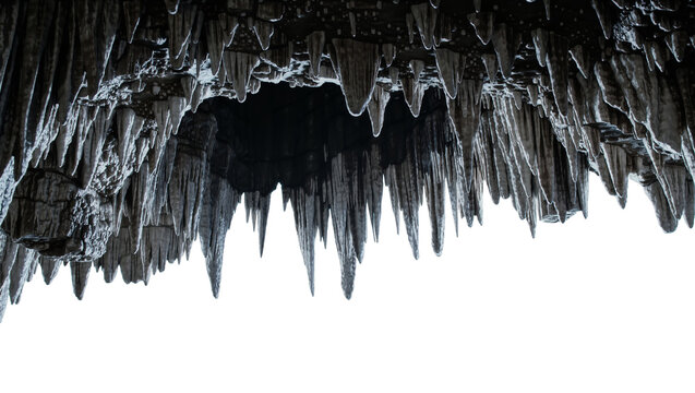 Dark stalactites hanging from a cave ceiling, isolated on transparent background