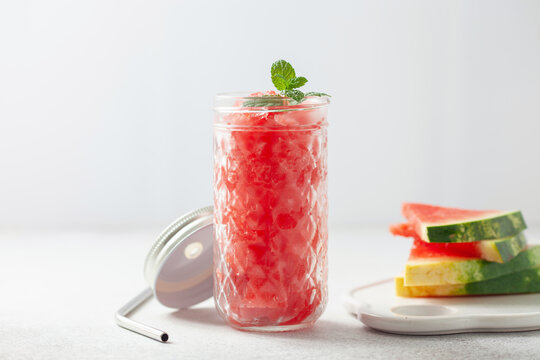 Refreshing cold summer drink watermelon slushie with mint in glass
