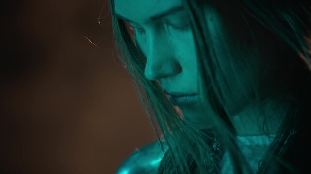 Caucasian young woman wearing chainmail armor standing with eyes closed during camera tilt up. Suitable for fantasy film trailers, historical storytelling, or gaming commercials