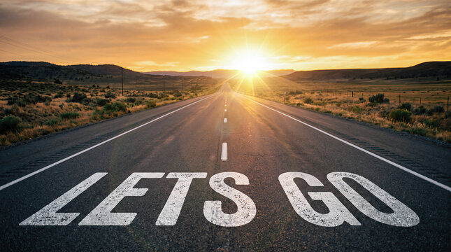 Lets go text written empty asphalt highway straight road fast motion blur bright golden sunset mountains beautiful summer travel journey transportation