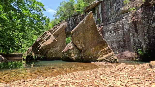 Shimmering sun reflections dance on the famous Devil's Backbone sandstone formation rising out of a natural pool at Bell Smith Springs in Shawnee National Forest.