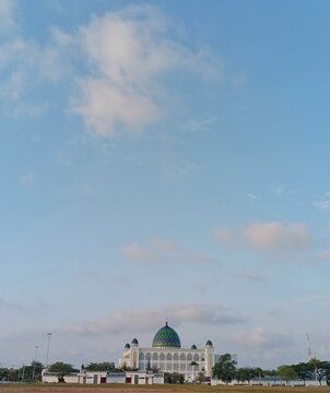 Beautiful view of Islamic Center Great Mosque of Al-Ikhlas in Penajam Paser Utara under cloudy blue sky.