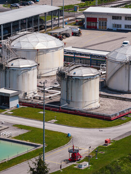 Oil storage facility shows large tanks and industrial structures in an aerial view. This site represents energy infrastructure for fuel.