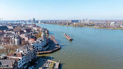 Obraz premium View of river shipping and historic riverside city in Europe