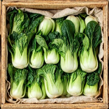 Fresh bok choy in a wooden market crate