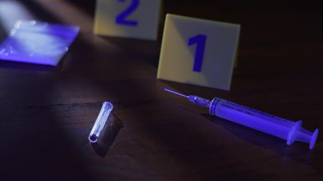 Investigator POV scanning syringe, drug baggie, and evidence markers at dark crime scene with window shadows under flashing police lights, look around
