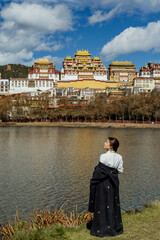 Side profile portrait of woman by the lake, Songzanlin Monastery reflected © nhat.photograph