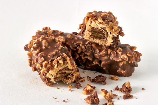Broken Chocolate Wafer Bars with Crushed Nuts on White