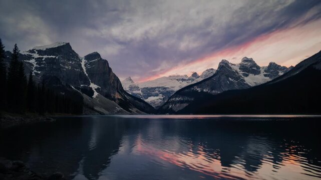 Majestic mountain range reflection during vibrant sunset sky over calm lake cinematic motion
