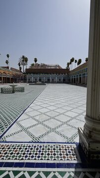 Marrakech, morocco. August 10, 2026. Slow motion view of the large courtyard at bahia palace in marrakech, morocco, revealing traditional zellij mosaic tilework and architecture