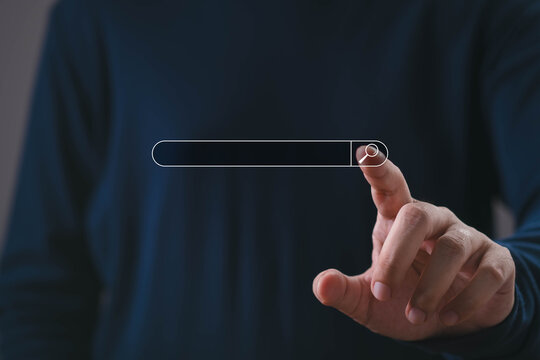 Digital search concept showing a professional hand interacting with a search bar and magnifying glass, representing online research, information discovery, browsing, technology, and business search.