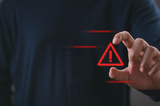 Cybersecurity system warning concept showing a professional hand interacting with a red alert interface, data protection, digital security, technology risk and threat monitoring for business.