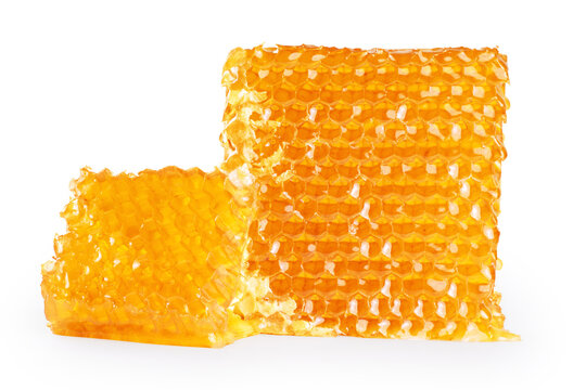 Piece of wax honeycomb filled with honey, isolated on white background.