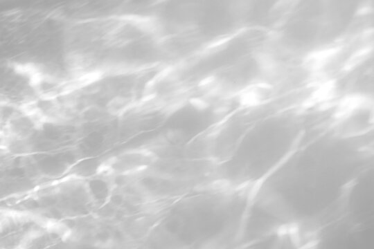Real high-density water caustic shadow cut out on a transparent png background with soft shimmering edges. Anchors a serene summer beauty campaign and wellness hero design as a png overlay.