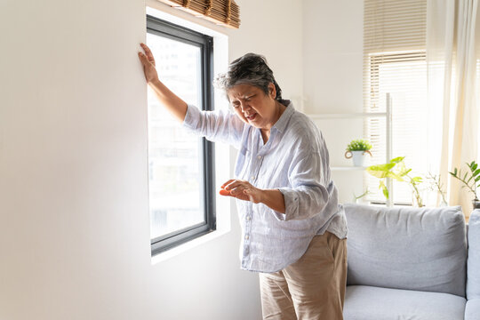 Aged woman feel dizzy and headache at home.