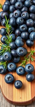 Fresh blueberries clustered on a wooden board with rosemary, natural, rustic