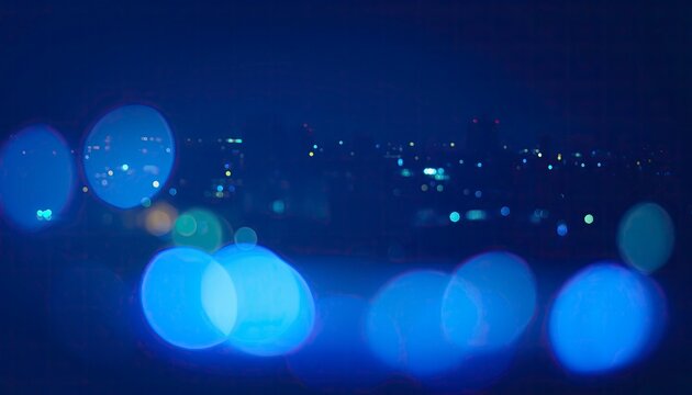 Night Cityscape Bokeh: A dreamy, out-of-focus view of a city at night, with glowing blue and white bokeh lights creating a magical, abstract atmosphere.