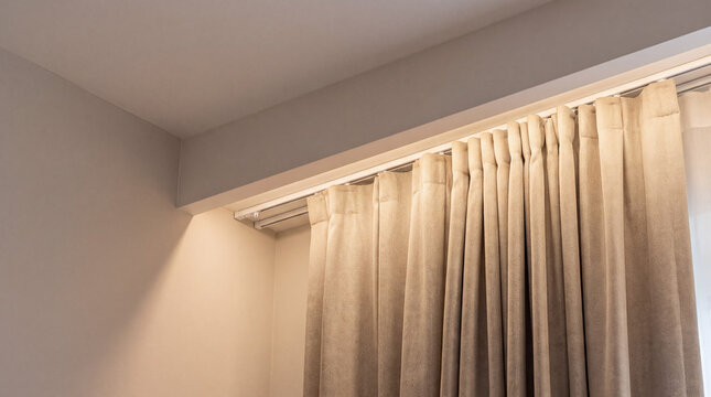 Hanging curtain on a window with ambient lighting creating a warm home interior atmosphere