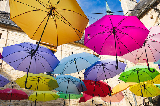 Colorful umbrellas cover a restaurant courtyard in Bayeux in the Normandy region of France