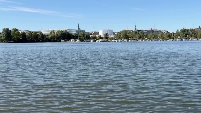 Calm Helsinki City Bay With Trees and Buildings on the Far Shore