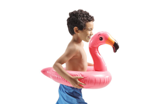 Happy boy running with an inflatable flamingo swimming ring