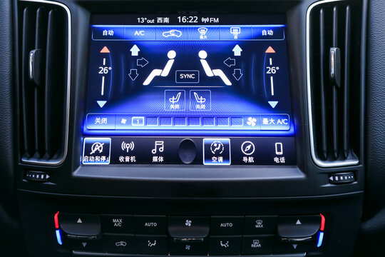 Close-up of the luxurious car dual-zone air conditioning touch screen on the modern car's center console. Translation: Air conditioning control