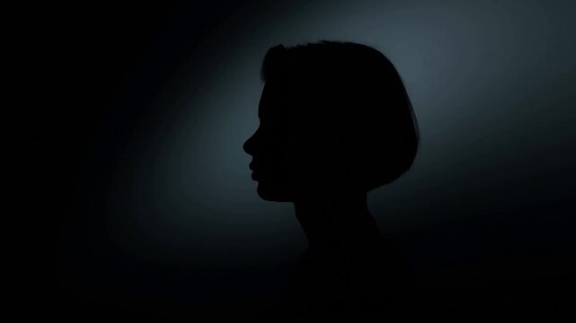 Woman Side Profile Silhouette Against Dark Blue Backlight in Quiet Stillness