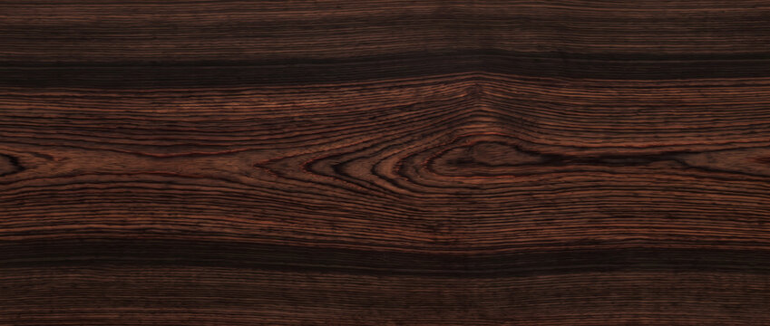 Exotic dark wood texture background showing rich ebony rosewood timber grain with striking banded cathedral pattern for design use