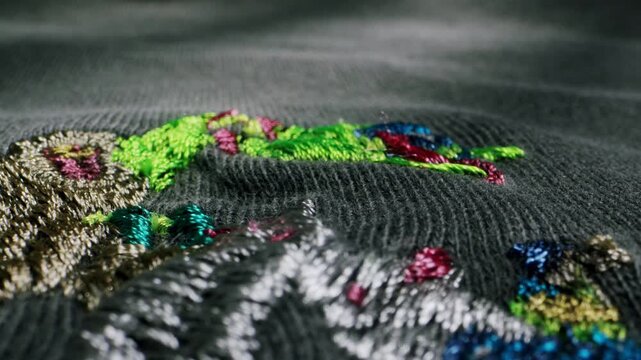 Colorful embroidery on fabric with threads, macro close-up of handmade stitching detail