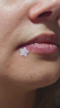 Woman's finger gently touches her lips, revealing a close up of clear, healthy skin and moisturized lip texture, highlighting concepts of skincare, hydration, and natural beauty routine