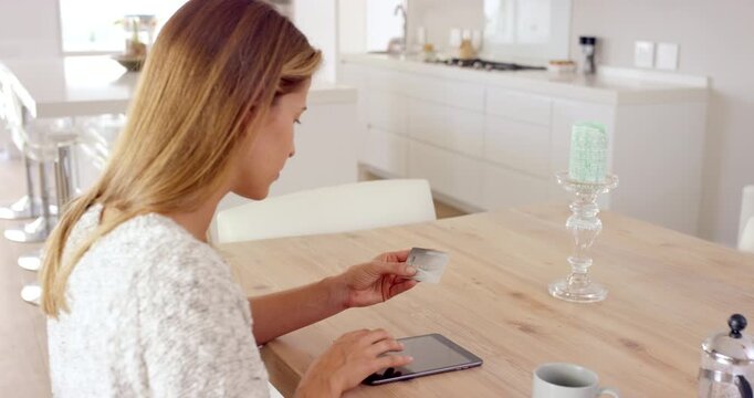 Home, credit card and woman with tablet for ecommerce, subscription payment and digital transaction. Online shopping, virtual purchase or person with fintech for checkout, typing bank details or info