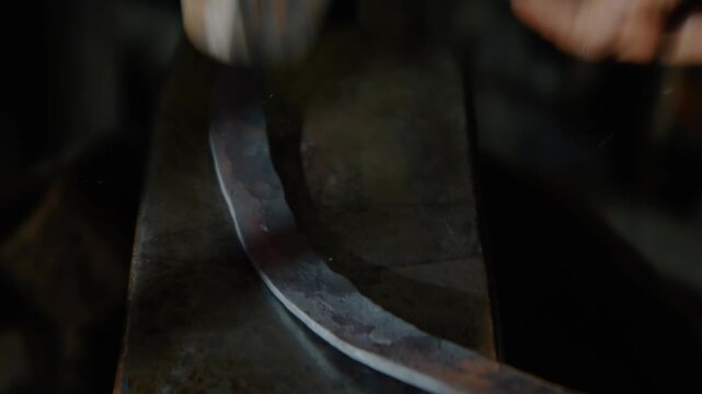 Blacksmith Forging Hot Metal with Sledgehammer on Anvil