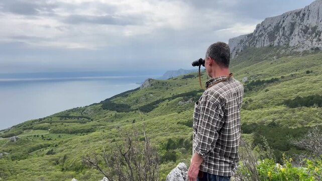 Man Observing Mountains, Forest and Sea From Viewpoint