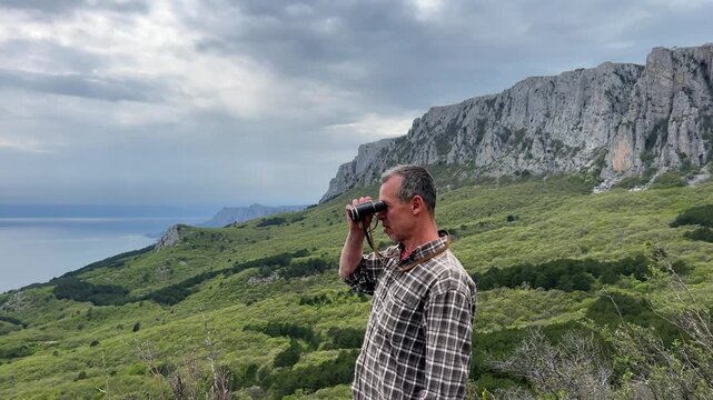 Mature Traveler Observing Mountains From High Altitude