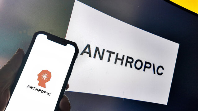 a computer screen and smartphone  with anthropic displayed....